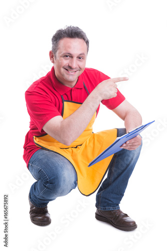 Cheerful retailer in the store doing inventory photo