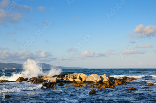 Sea surf wave break on stone
