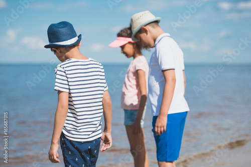 selective focus of multicultural little children standing at seaside © LIGHTFIELD STUDIOS