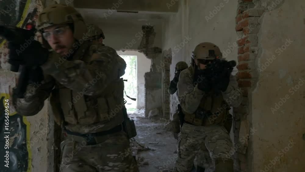 Slow motion of special forces army squad running and spreading through ruins of building in military exercise Slow motion of special forces army squad running and spreading through ruins of building in military exercise