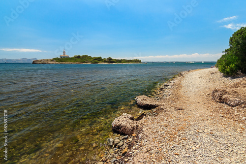 Aucanada virgin beach and lighthouse island in Alcudia, Balearic Islands