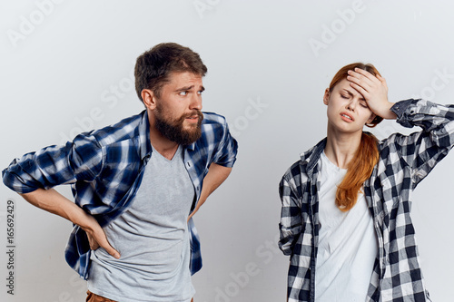 Man with a beard with a young beautiful girl on a light background, couple