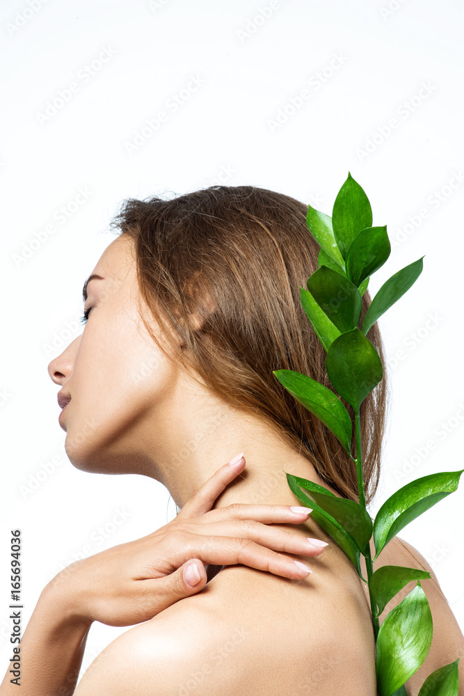 Beautiful woman face with green leaf Beautiful woman face with green leaf