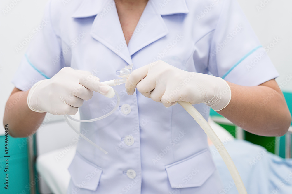 Nurse use Suction Machine, prepare to suction patient's mucus. Soft focus. Nurse use Suction Machine, prepare to suction patient's mucus. Soft focus.