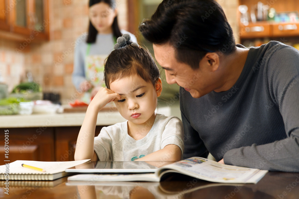 Father helping daughter with her study Father helping daughter with her study