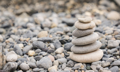 Small tower made of pebbles on a rocky beach
