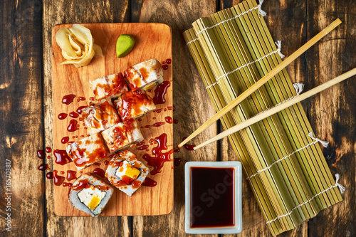 Sushi, rolls with eel on a wooden stand. photo