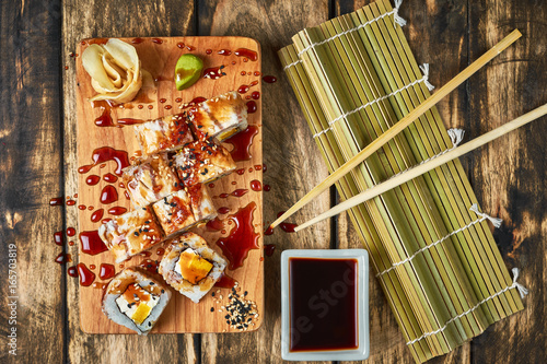 Sushi, rolls with eel on a wooden stand. photo