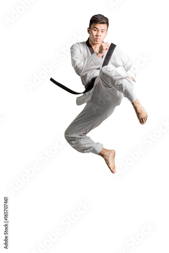 Portrait of an asian professional taekwondo black belt degree (Dan) jumping for kick. Isolated full length on white background with copy space and clipping path