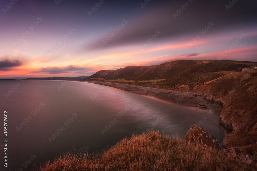 Sunset at Rhossili Bay at the far tip of the Gower peninsula, South Wales, UK