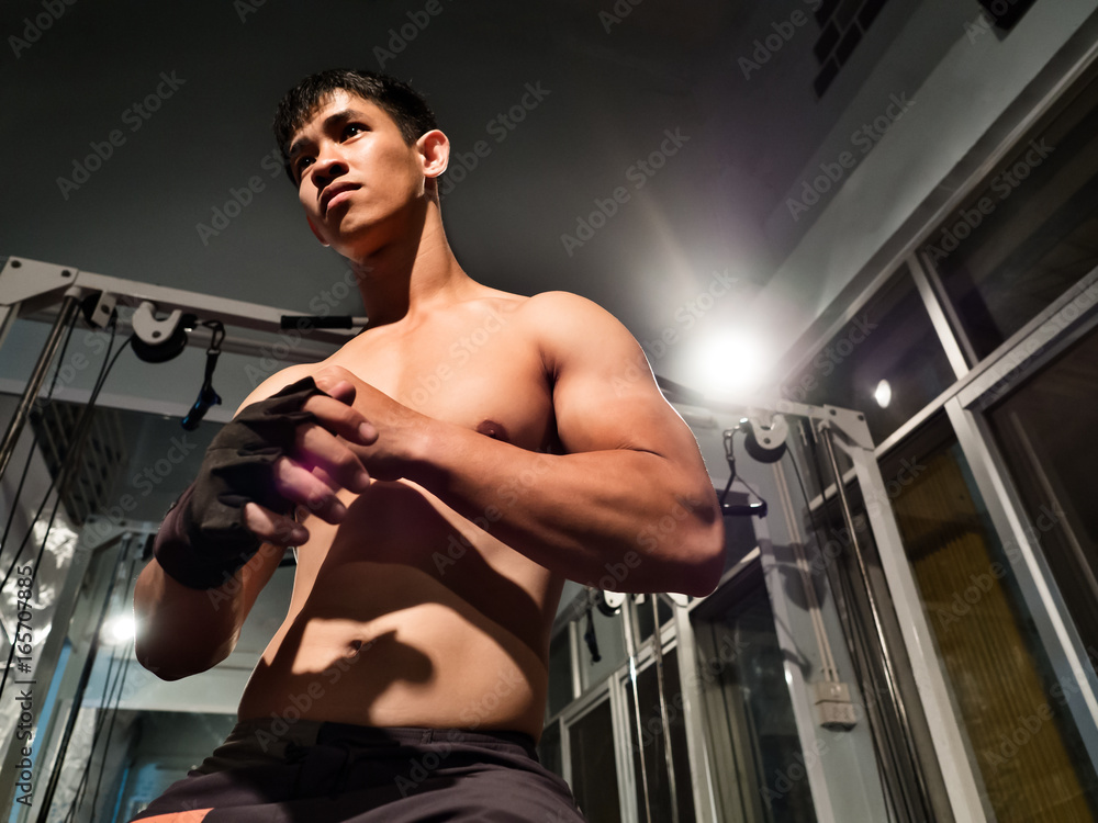 Close up portrait of fitness man and bodybuilder wearing a glove prepare to workout at gym show upper body biceps triceps muscles arms and torso Asian look Stock Photo Adobe Stock