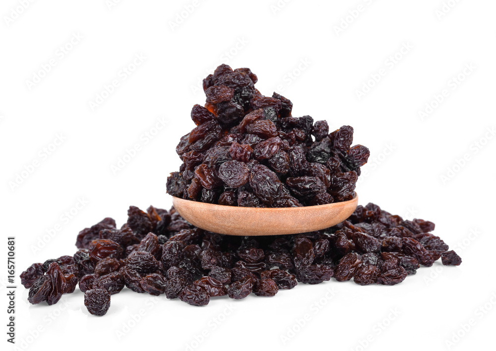 Dried Grapes into a spoon isolated in white background Dried Grapes into a spoon isolated in white background