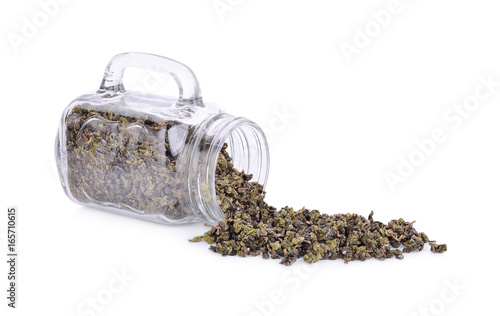 Tea leaves in a glass jar isolated from a white background.