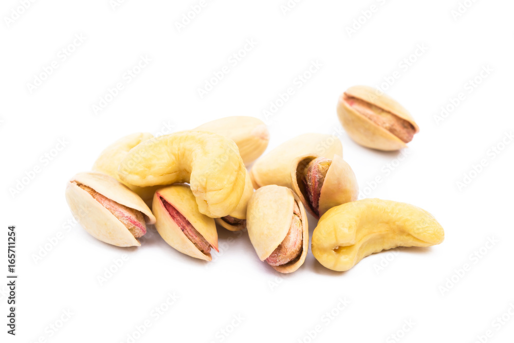 Pile of roasted pistachios and cashew isolated on white background Pile of roasted pistachios and cashew isolated on white background