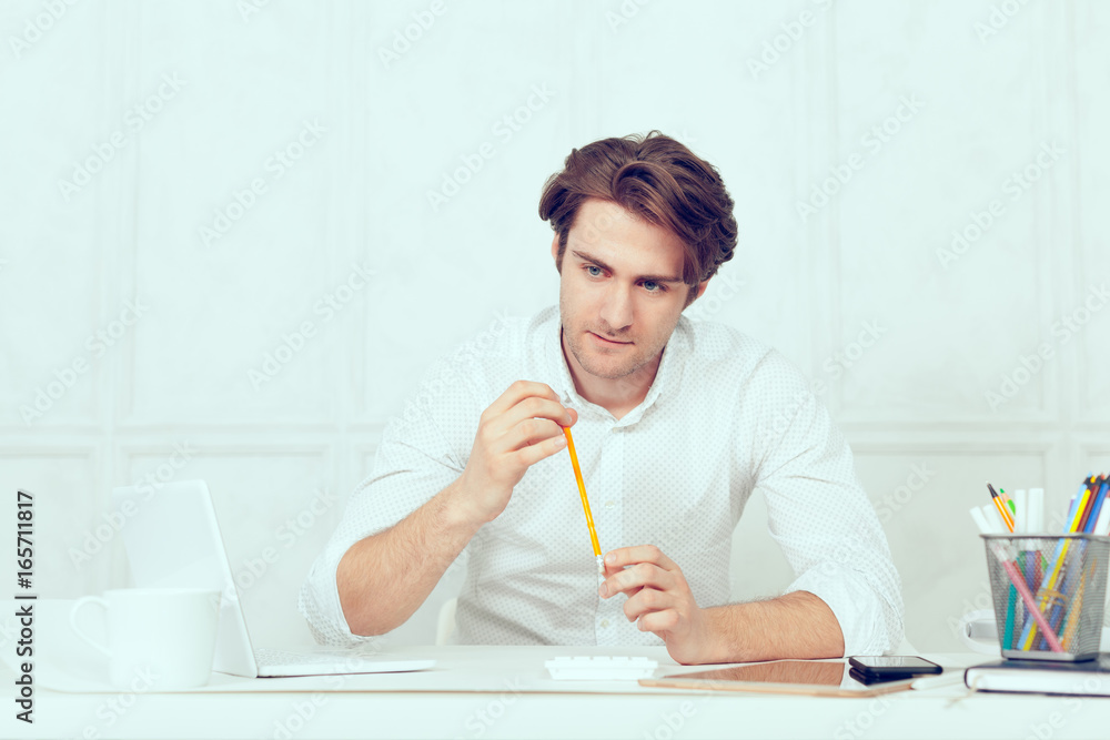 Businessman using laptop with tablet and pen Businessman using laptop with tablet and pen
