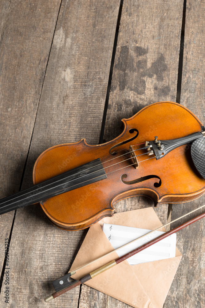 Sheet music and violin on wooden table