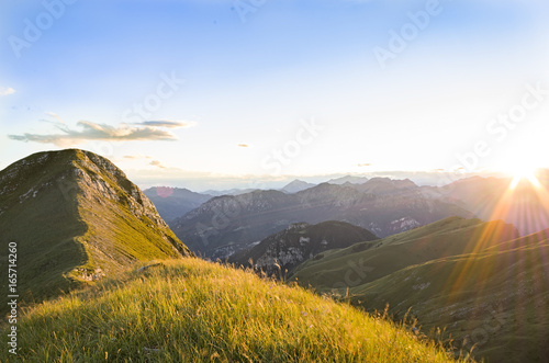 Sunset from a green top of a mountain
