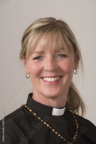Photography Portrai of a woman priest with blond hair and a big smile