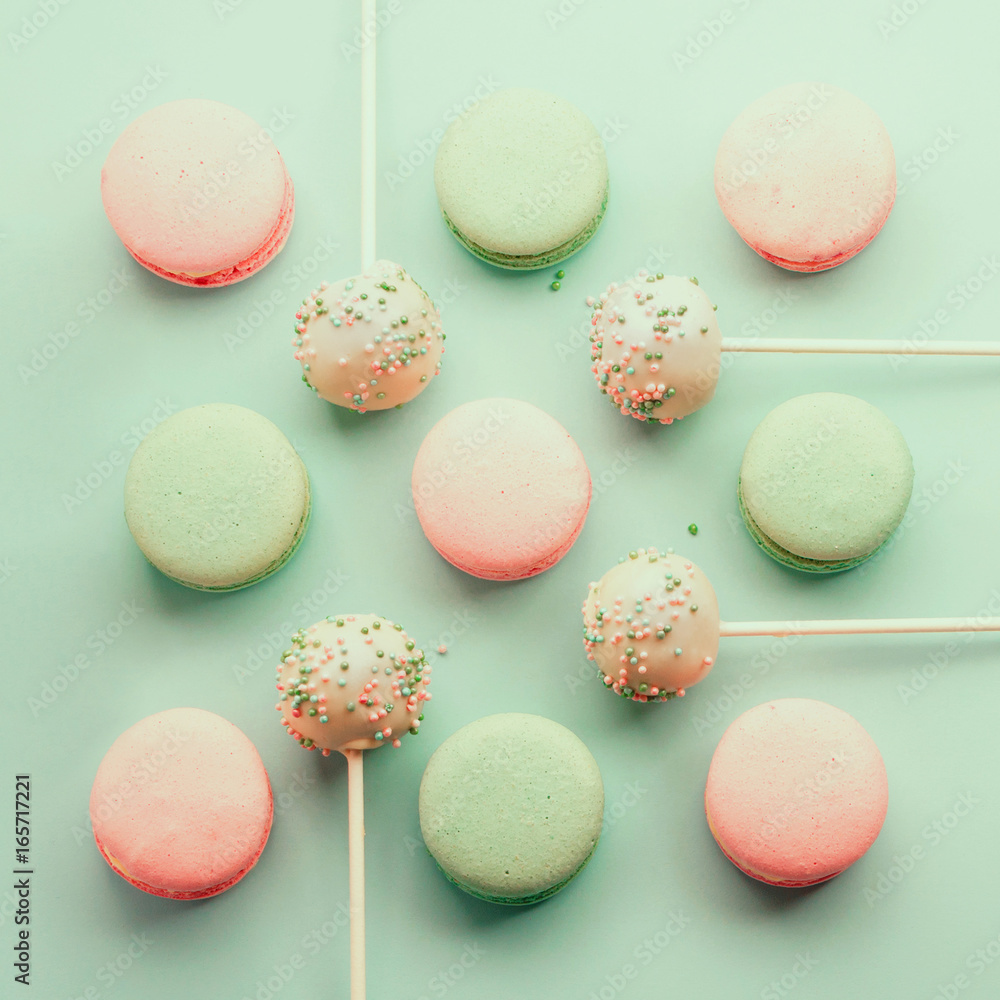 Colorful macaroons mixed with cake crumbs with icing on sticks. Top view. Flat lay.
