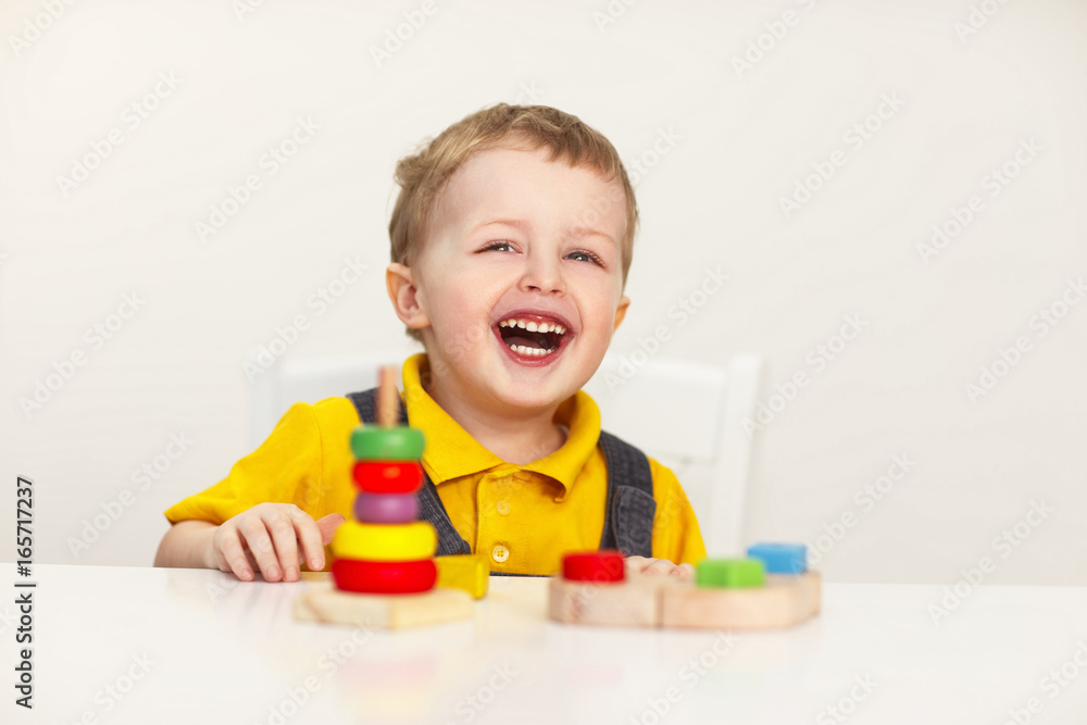 Laughing little boy with wooden toys Laughing little boy with wooden toys