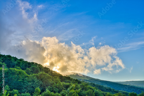 Mountains during sunset. Beautiful natural landscape in the summer time. Dramatic clouds in the blue sky in Carpathian mountains in Ukraine.