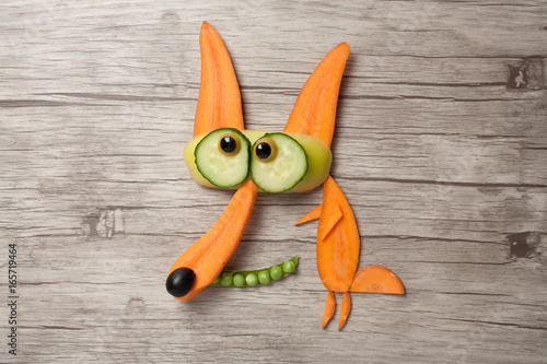 Funny vegetable fox made on wooden background