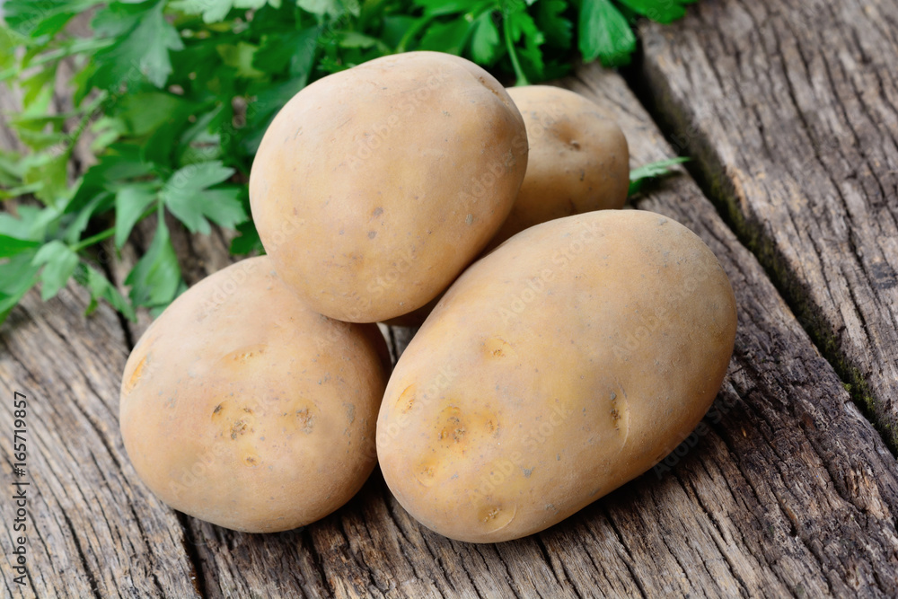 Group of potatoes with parsley on table Group of potatoes with parsley on table
