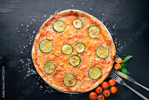 Zucchini Pizza. On a wooden background. Top view. Free space for your text.