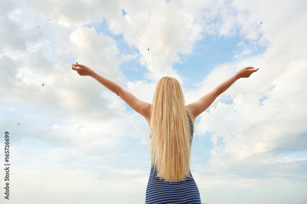 Girl in blue dress on sky background Girl in blue dress on sky background