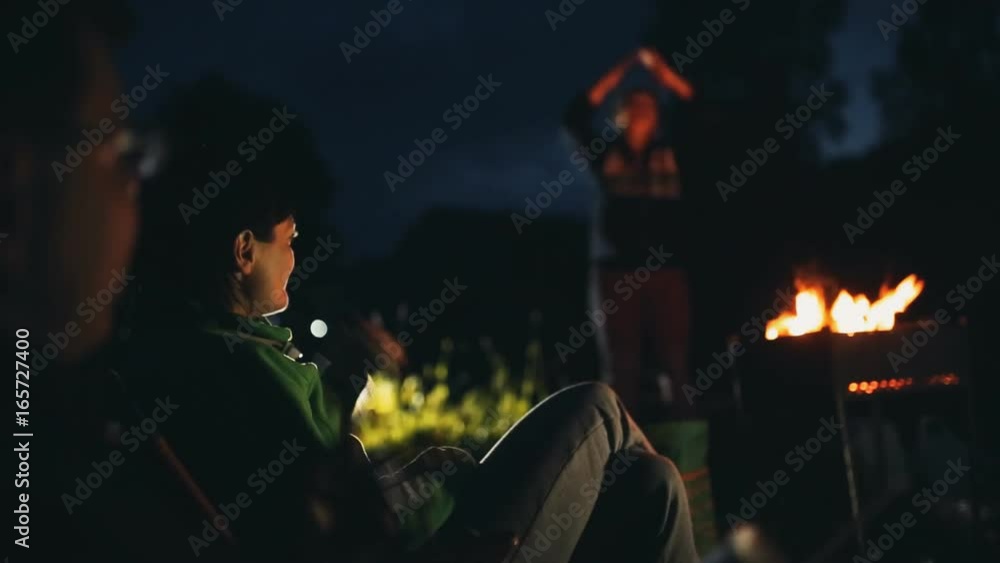 Group of friends sit in a forest Group of friends sit in a forest