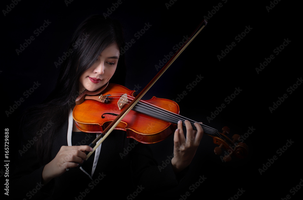 Playing the violin. Musical instrument with hands on dark background. Playing the violin. Musical instrument with hands on dark background.