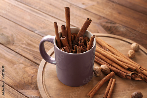 Composition with cinnamon sticks on wooden table