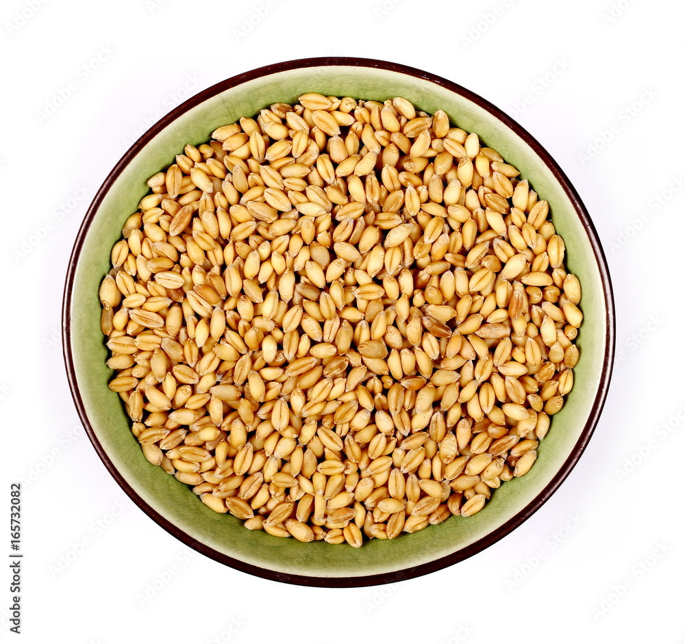 Wheat grains in bowl on white background, top view Wheat grains in bowl on white background, top view