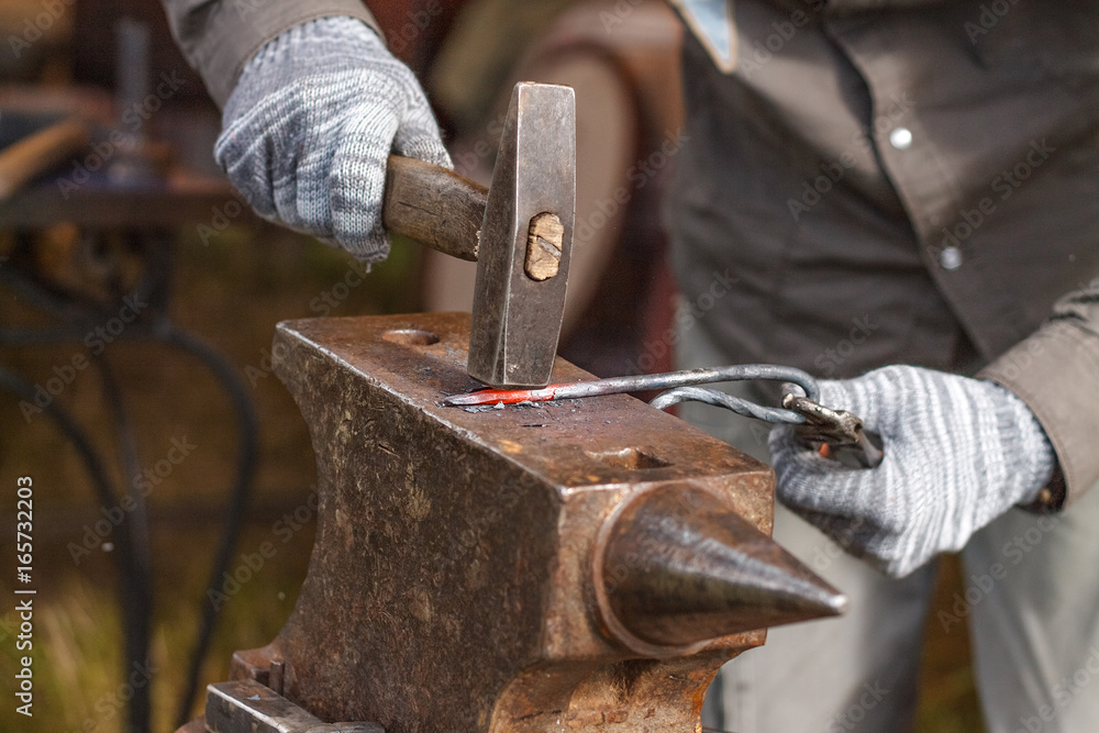Blacksmith working on metal on anvil at forge high speed detail shot Blacksmith working on metal on anvil at forge high speed detail shot