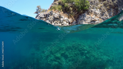 Fototapeta Naklejka Na Ścianę i Meble -  Half underwater close up, background split by waterline, Turkey, Mediterranean Sea,