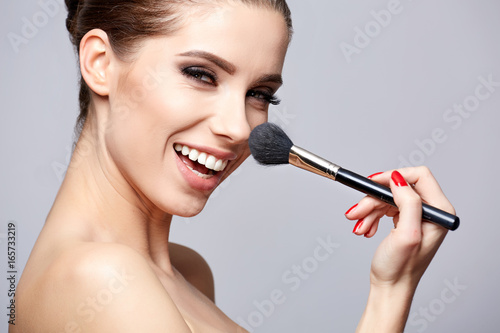 Beauty Girl with Makeup Brushes. Make-up for Brunette Woman. Beauty Face with smile