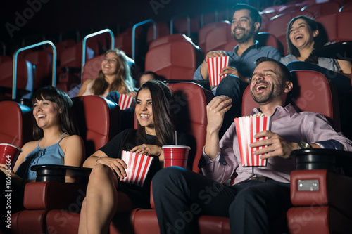 Group of people laughing at the movie theater