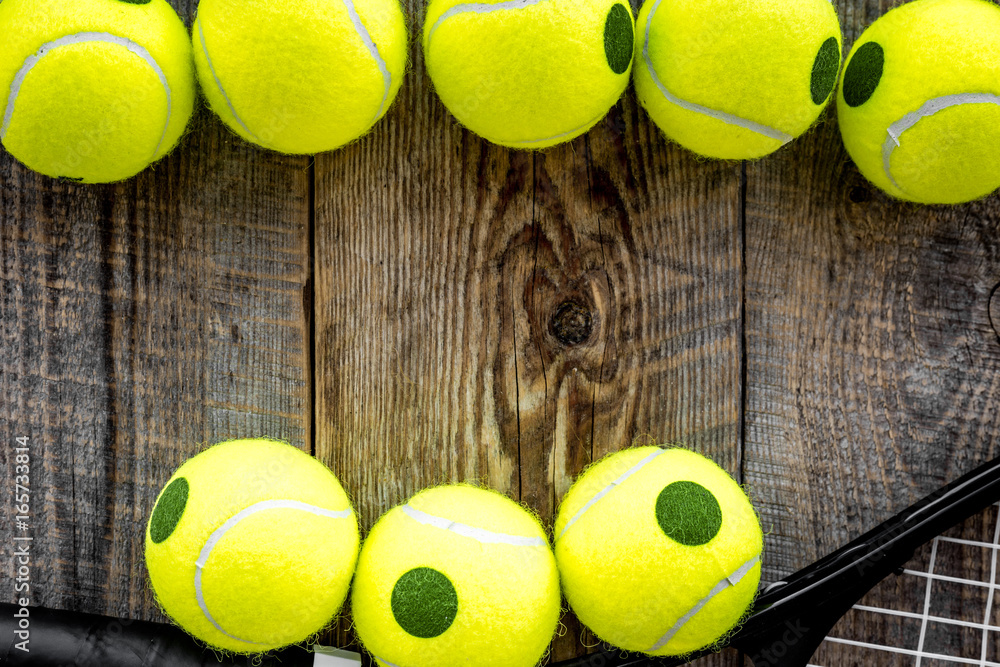 Sport background. Tennis balls on wooden background close up top view copyspace