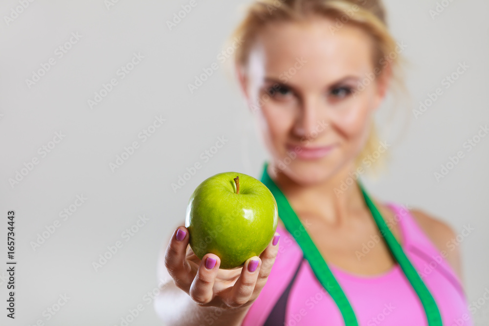 woman fit girl with measure tape and apple fruit woman fit girl with measure tape and apple fruit