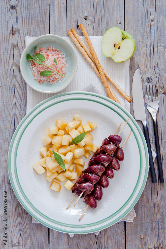 Grilled chicken hearts on skewers with stewed apples Grilled chicken hearts on skewers with stewed apples