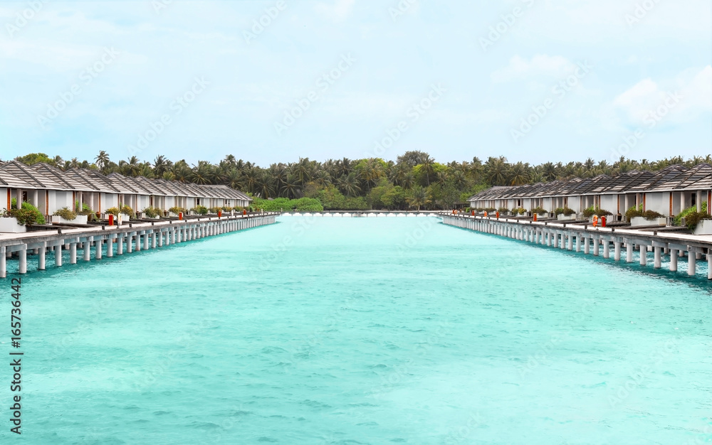 View of modern beach houses on piles at tropical resort