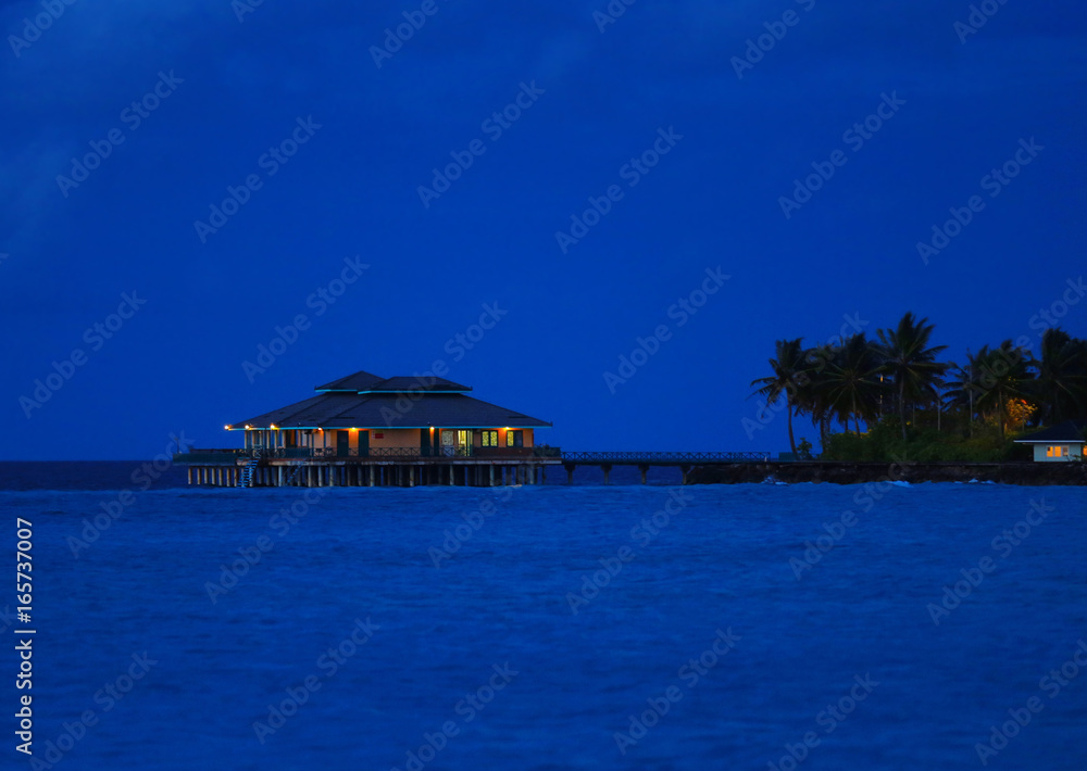 View of modern beach house at tropical resort in evening