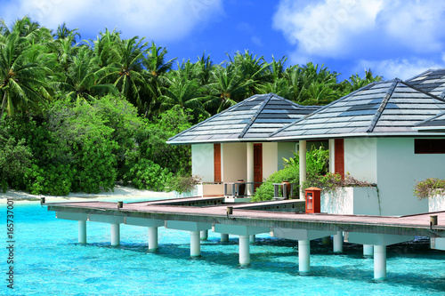 Modern beach houses on piles at tropical resort