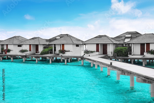 Modern beach houses on piles at tropical resort