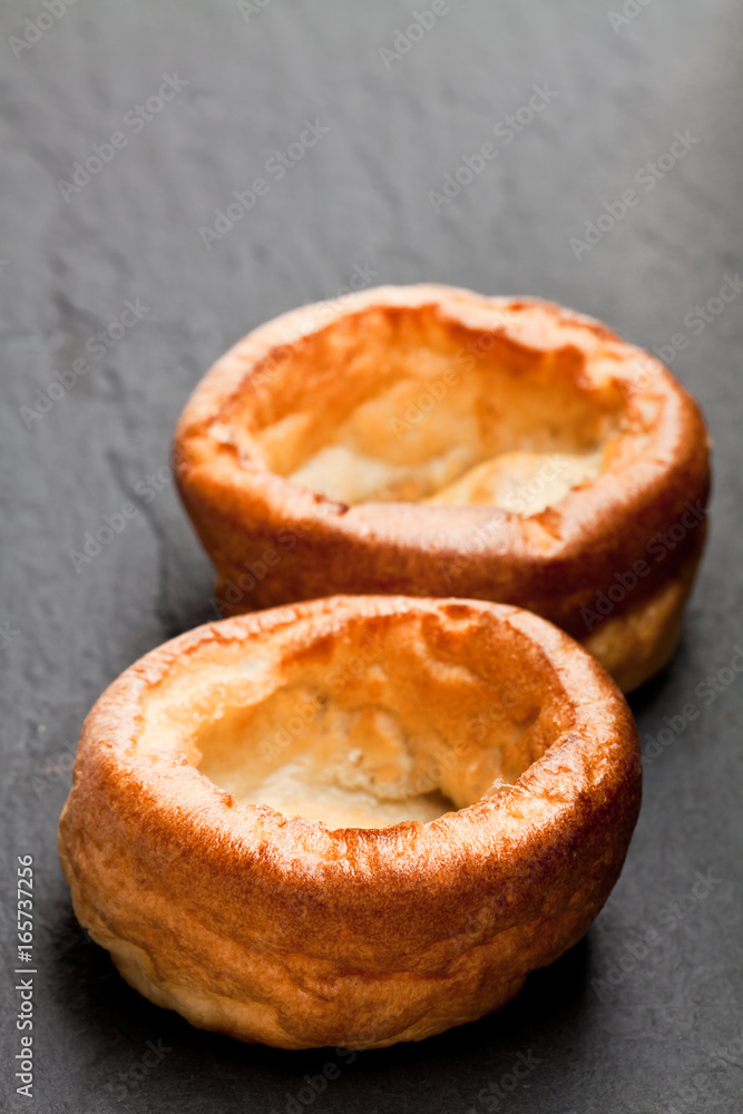Yorkshire puddings isolated on black stone background Yorkshire puddings isolated on black stone background