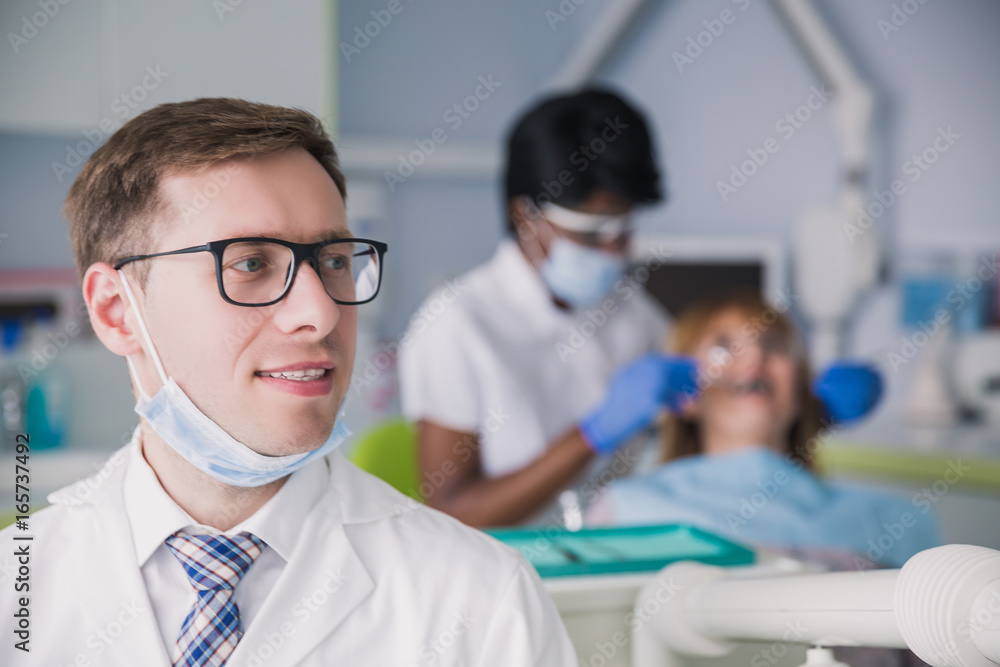 Portrait of an expert dentist in glasses Portrait of an expert dentist in glasses