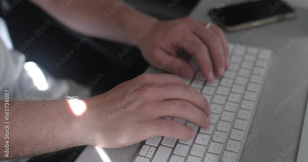 Remote worker using a keyboard in his home office for freelance business. Remote worker using a keyboard in his home office for freelance business.