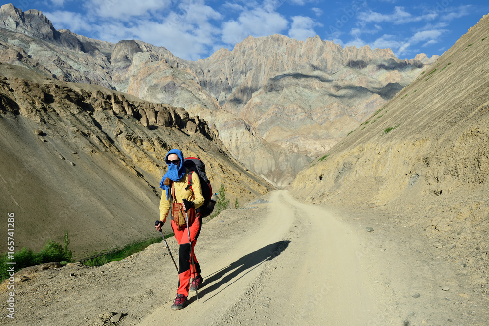 Tourist during expedition in the mountains Ladakh is admiring the beautiful Karakorum panorama.