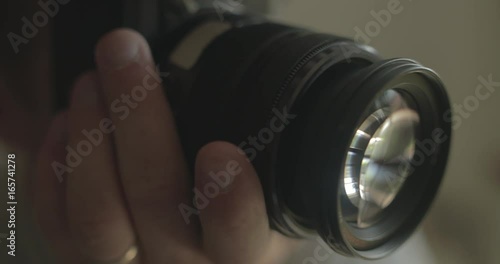 Man uses a digital camera at home for hobby photography.