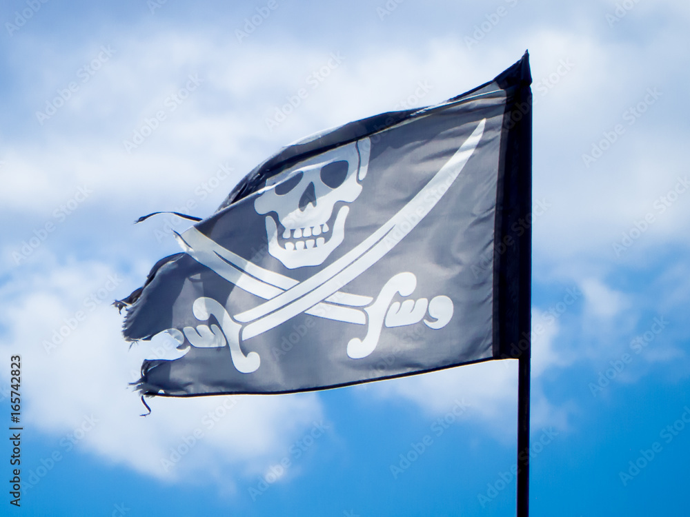 a jolly roger with a cloudy sky background a jolly roger with a cloudy sky background